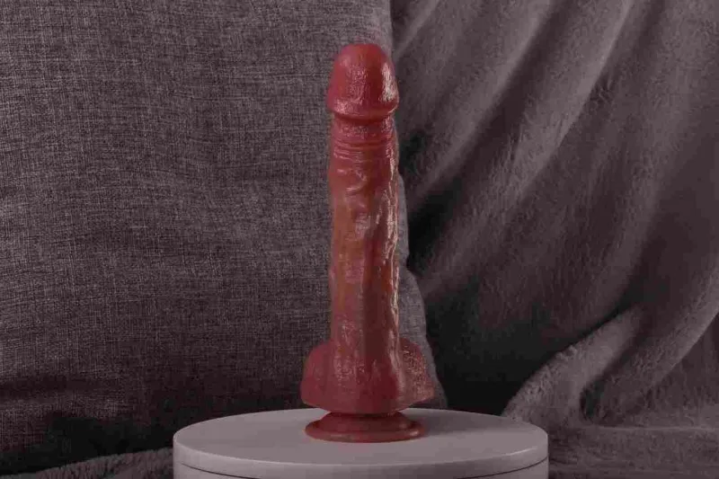 KY09 realistic dildo standing upright on a white surface in a room