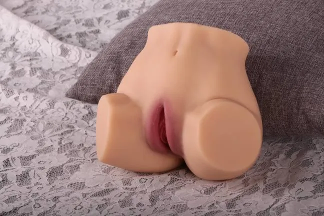 KY15 realistic hip masturbator photographed on a lace surface in a bedroom setting