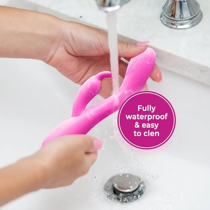 Pink KY22 waterproof vibrator being rinsed under running water for cleaning